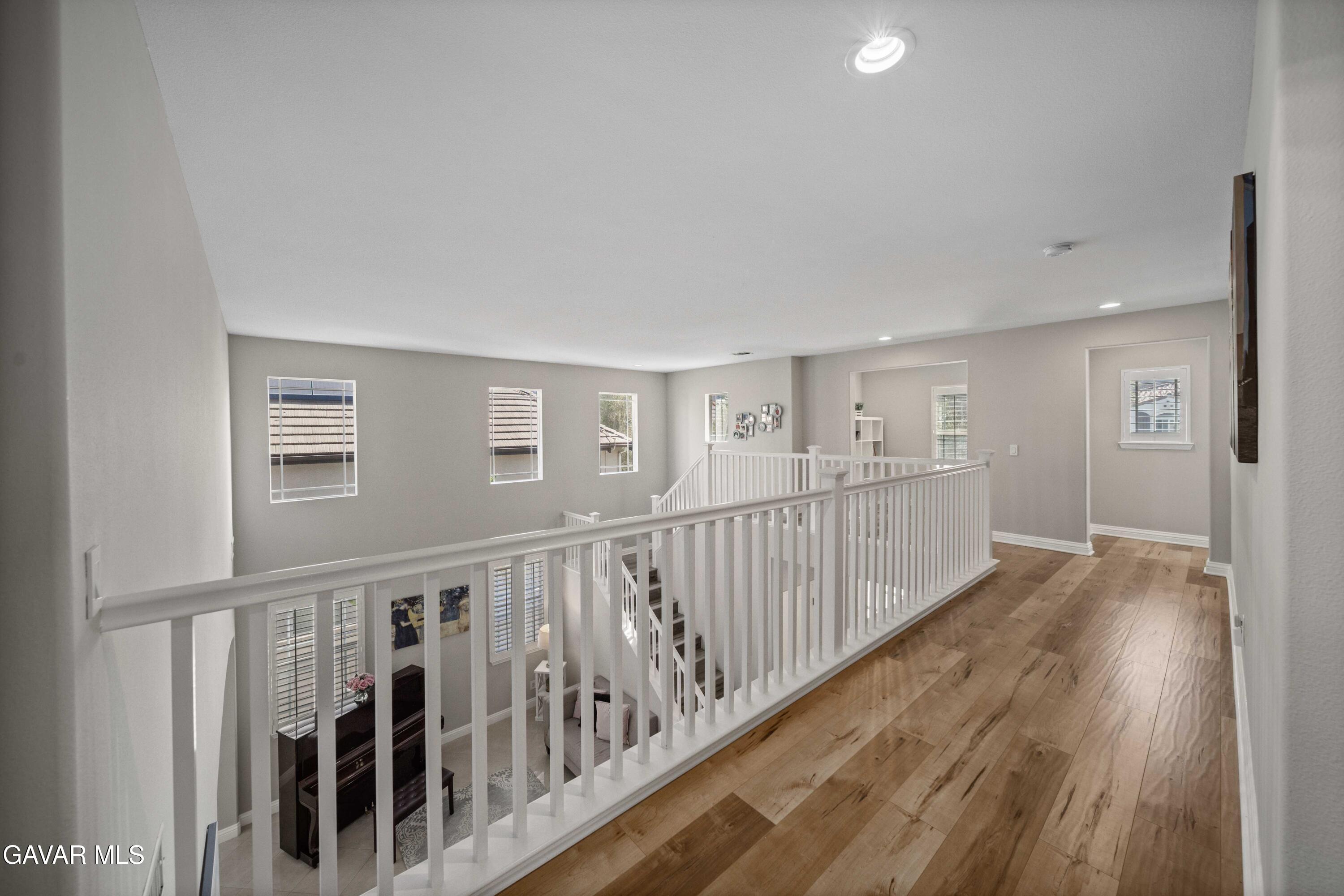 26505 Thackery Lane Stevenson Ranch, CA 91381 - Photo 37 of 63 a view of a hallway with wooden floor and windows