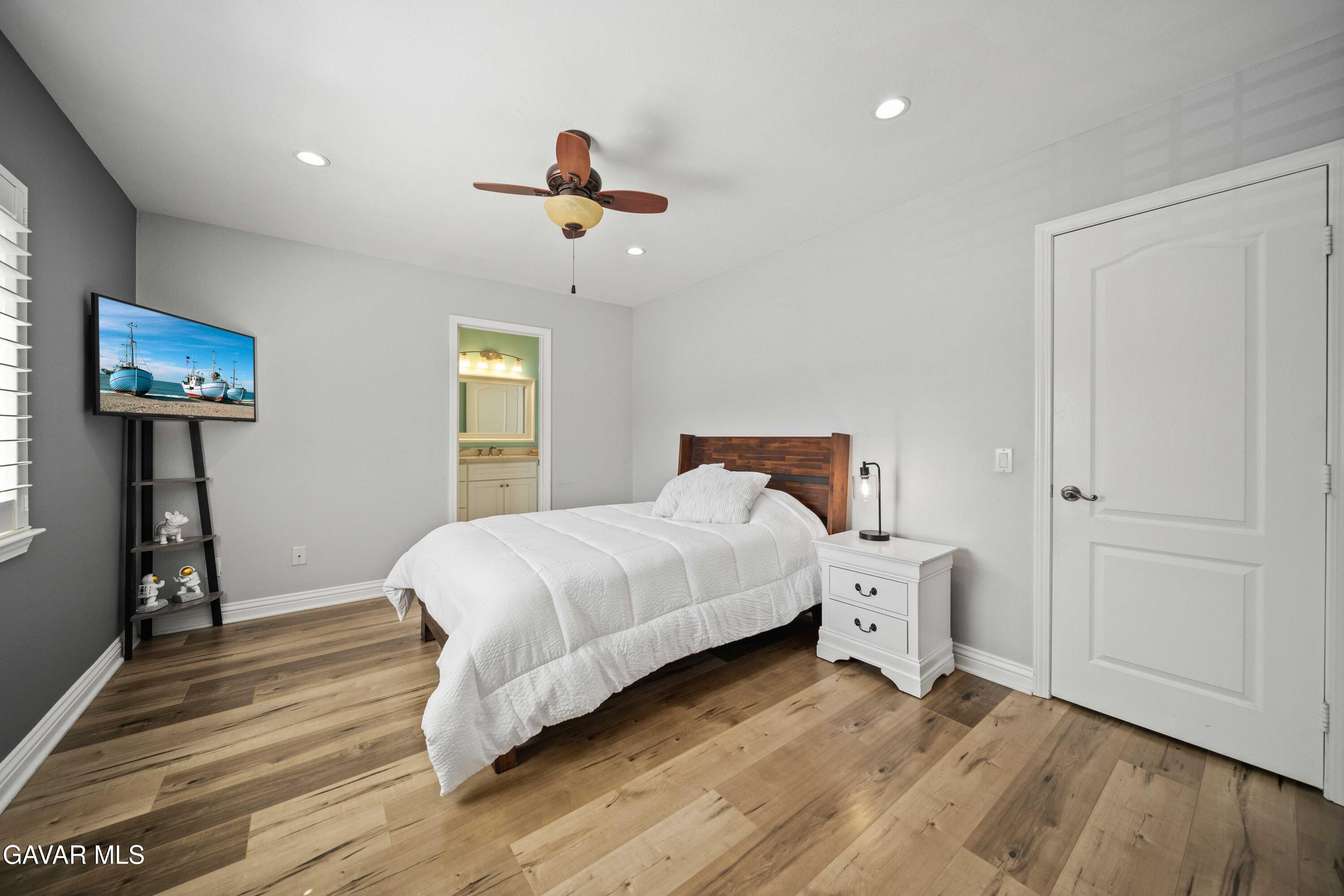 26505 Thackery Lane Stevenson Ranch, CA 91381 - Photo 38 of 63 a bedroom with a bed and wooden floor