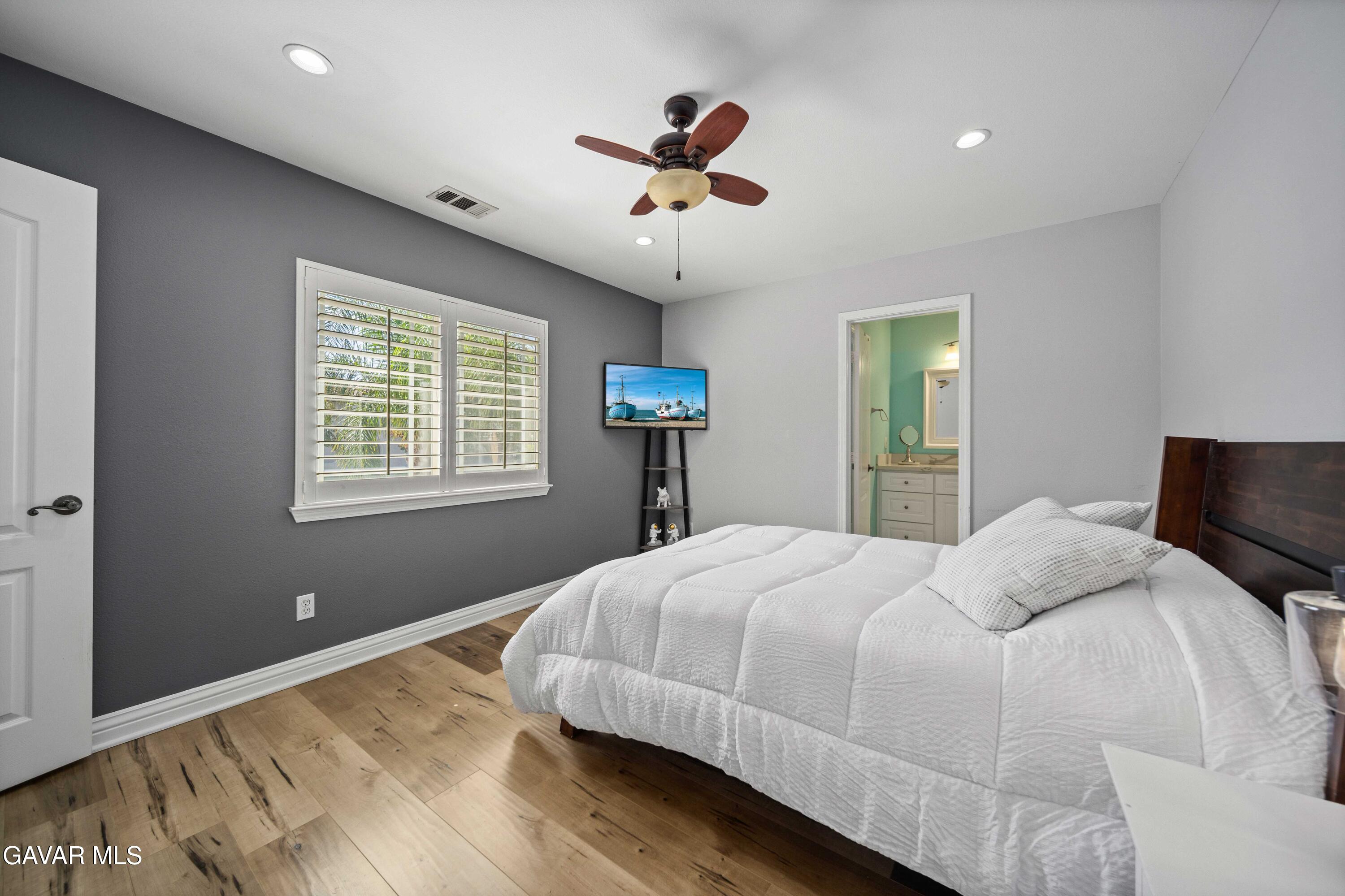 26505 Thackery Lane Stevenson Ranch, CA 91381 - Photo 39 of 63 a bedroom with a bed and a chandelier