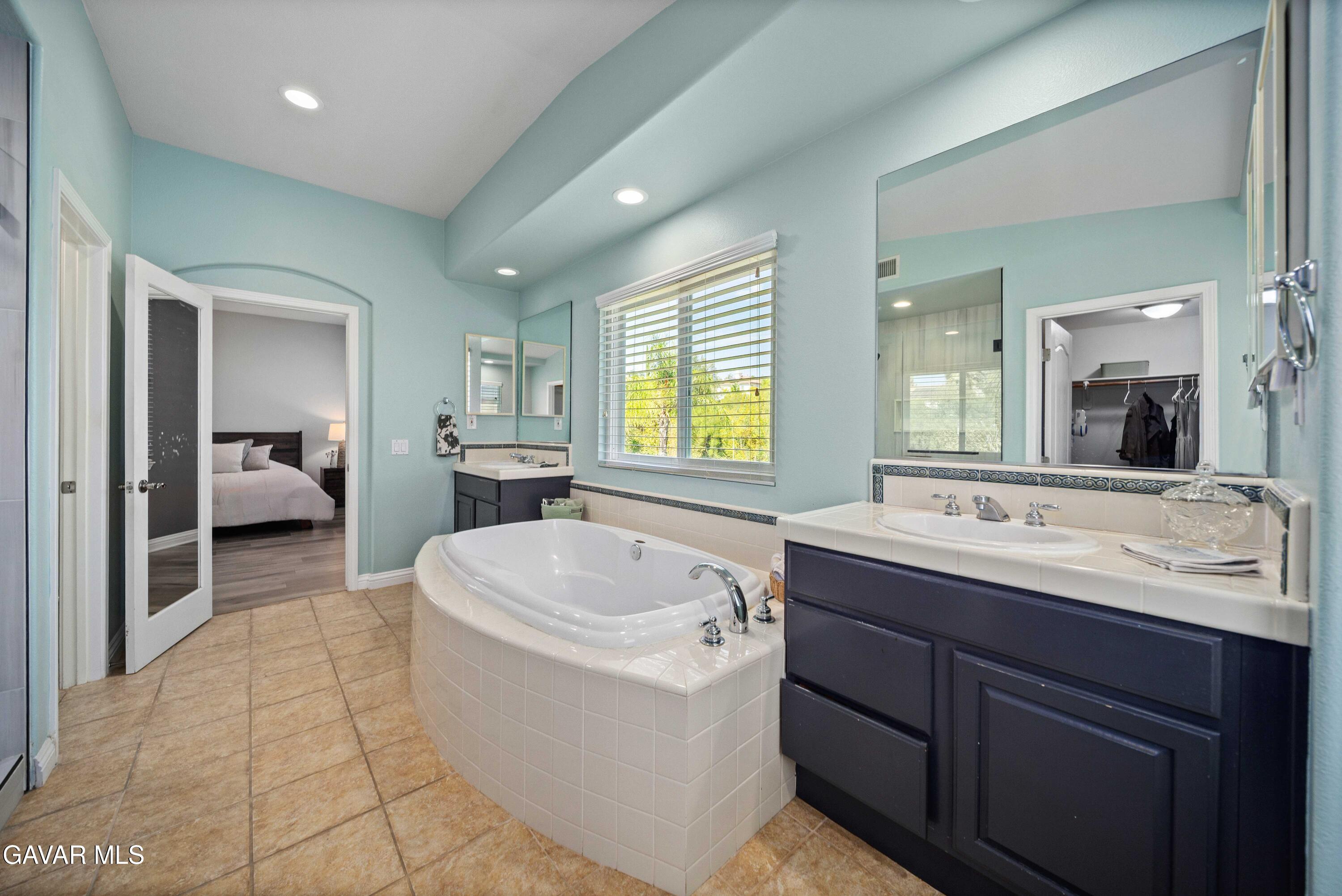 26505 Thackery Lane Stevenson Ranch, CA 91381 - Photo 53 of 63 a bathroom with a sink a large mirror and a vanity