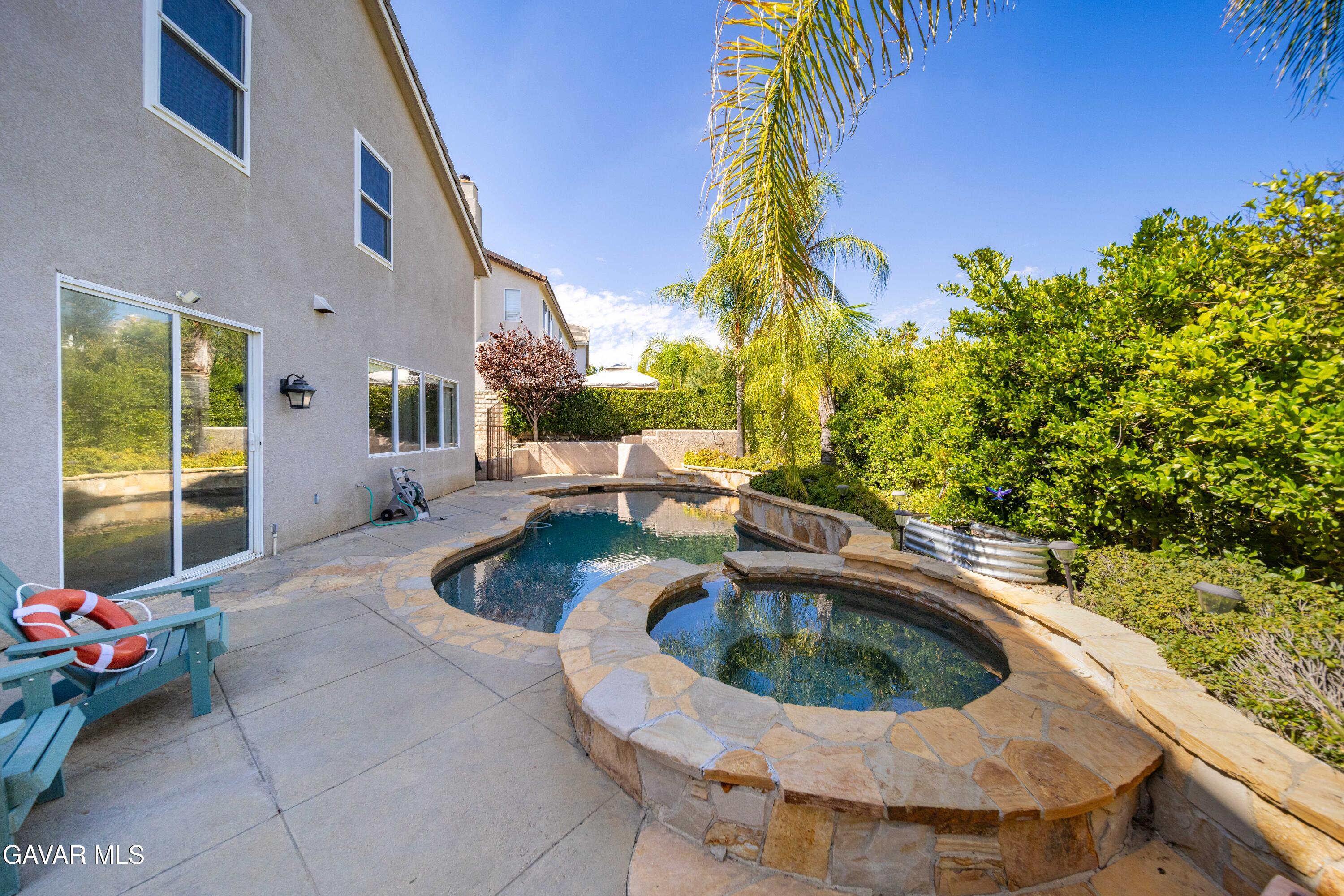26505 Thackery Lane Stevenson Ranch, CA 91381 - Photo 58 of 63 a view of a swimming pool with a patio