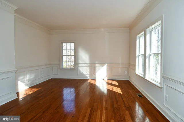 a kitchen with white cabinets and sink