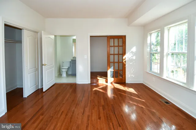 a bath tub sitting next to a white toilet and a shower