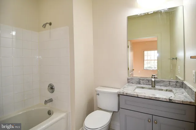 a view of a room with wooden floor and window