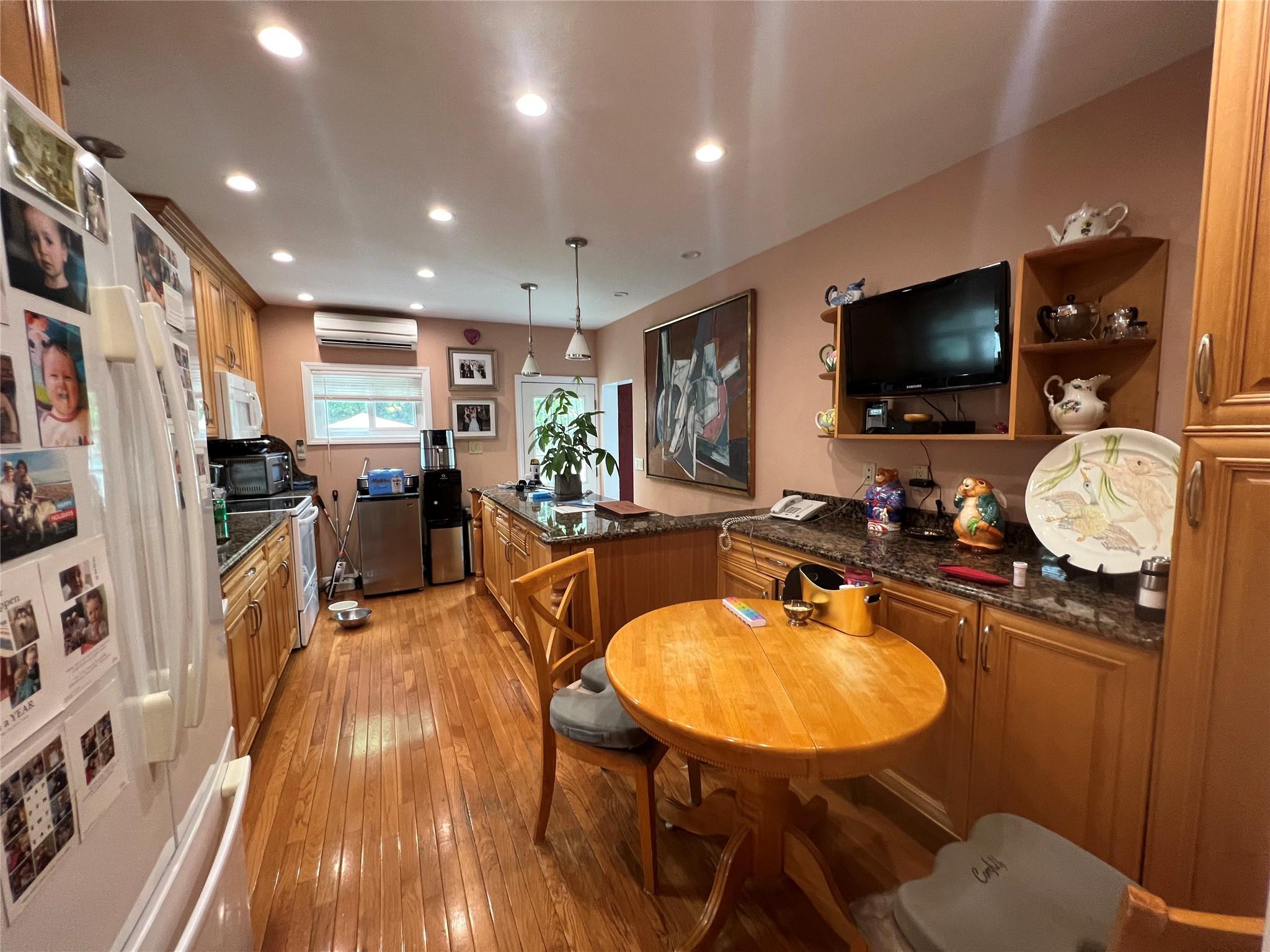 11 Pearl Street Valley Stream, NY 11581 - Photo 4 of 17 a living room with furniture flat screen tv and kitchen view