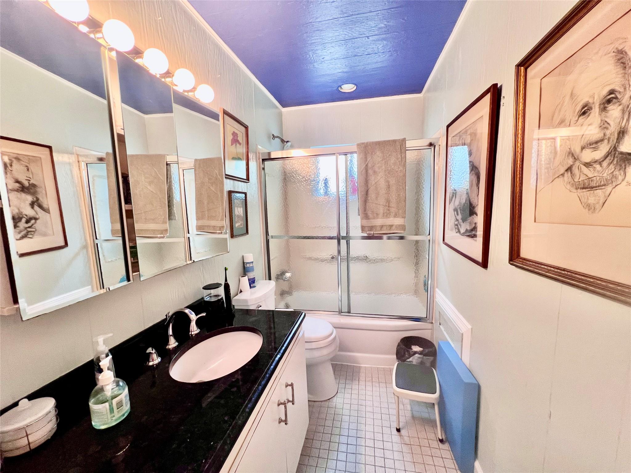 11 Pearl Street Valley Stream, NY 11581 - Photo 9 of 17 a bathroom with a granite countertop sink a mirror a vanity and a shower