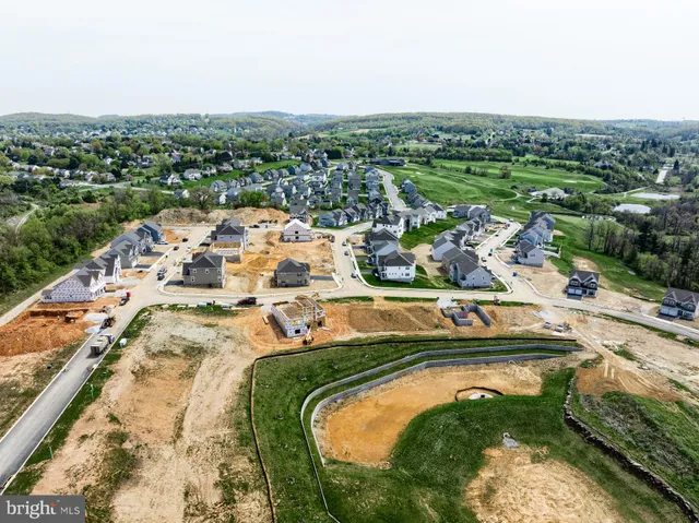 an aerial view of residential building and lake