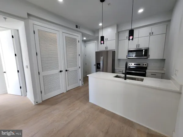 a view of kitchen and refrigerator
