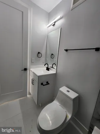 a bathroom with a sink toilet and mirror