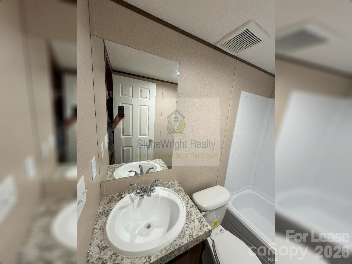 2034 Shelby Road, Unit 8 Kings Mountain, NC 28086 - Photo 5 of 8 a bathroom with a sink toilet and shower