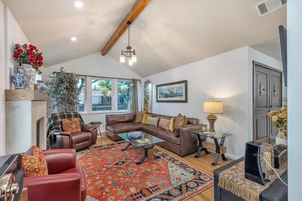 a living room with a fireplace a flat screen tv and a fireplace