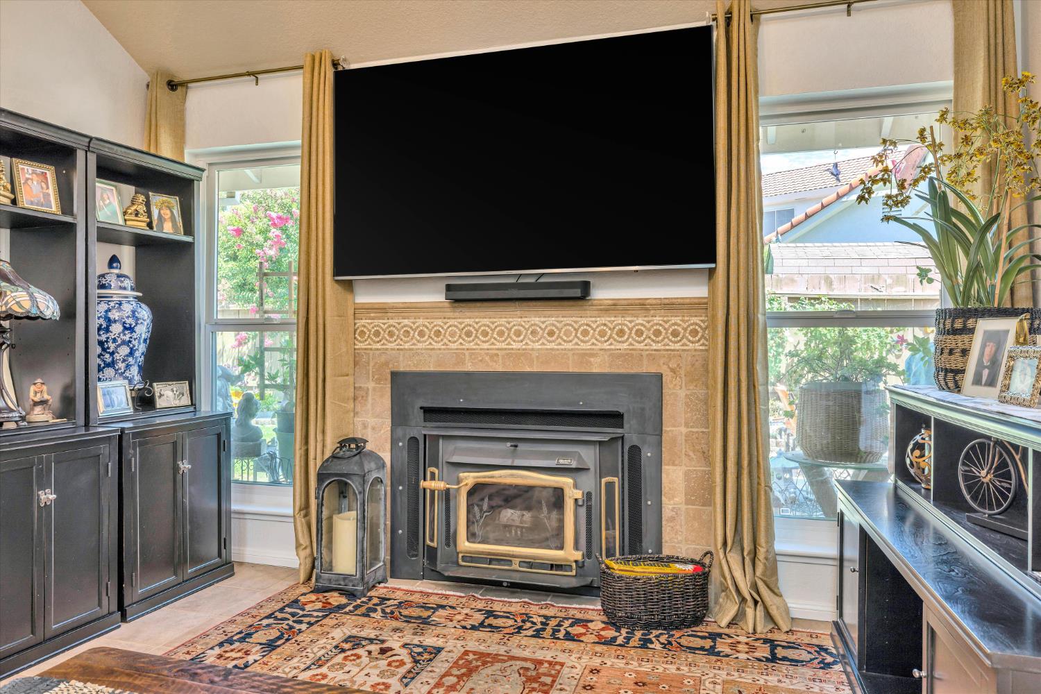 1412 Seneca Place Modesto, CA 95358 - Photo 14 of 62 a living room with a fireplace a flat screen tv and a fireplace