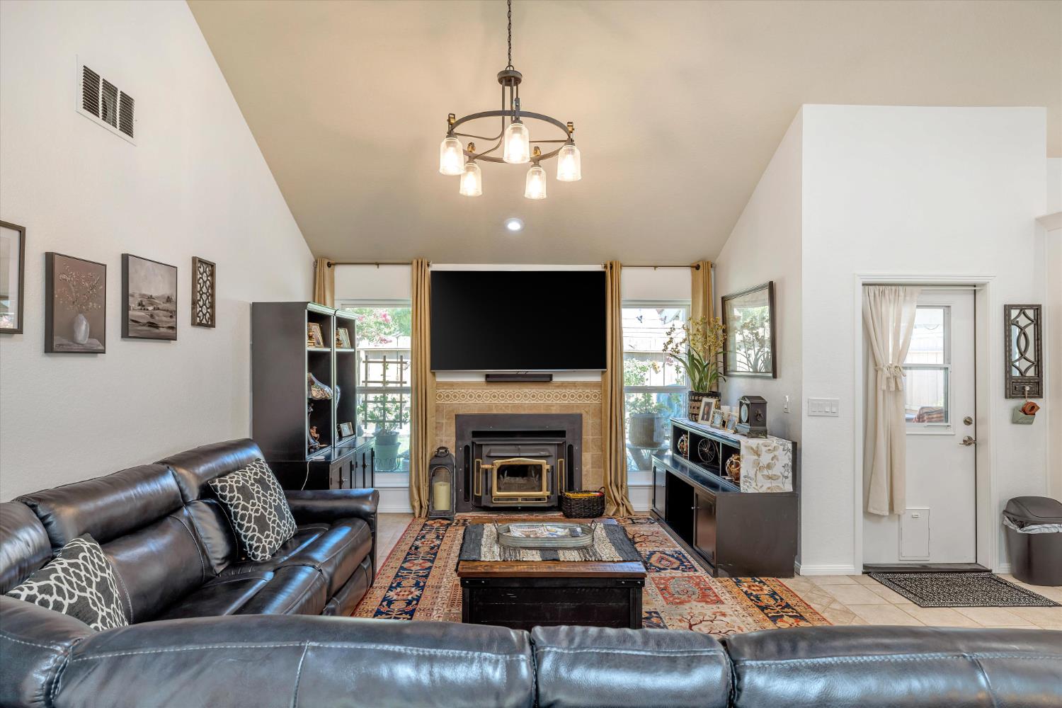 1412 Seneca Place Modesto, CA 95358 - Photo 15 of 62 a living room with furniture a flat screen tv and a fireplace