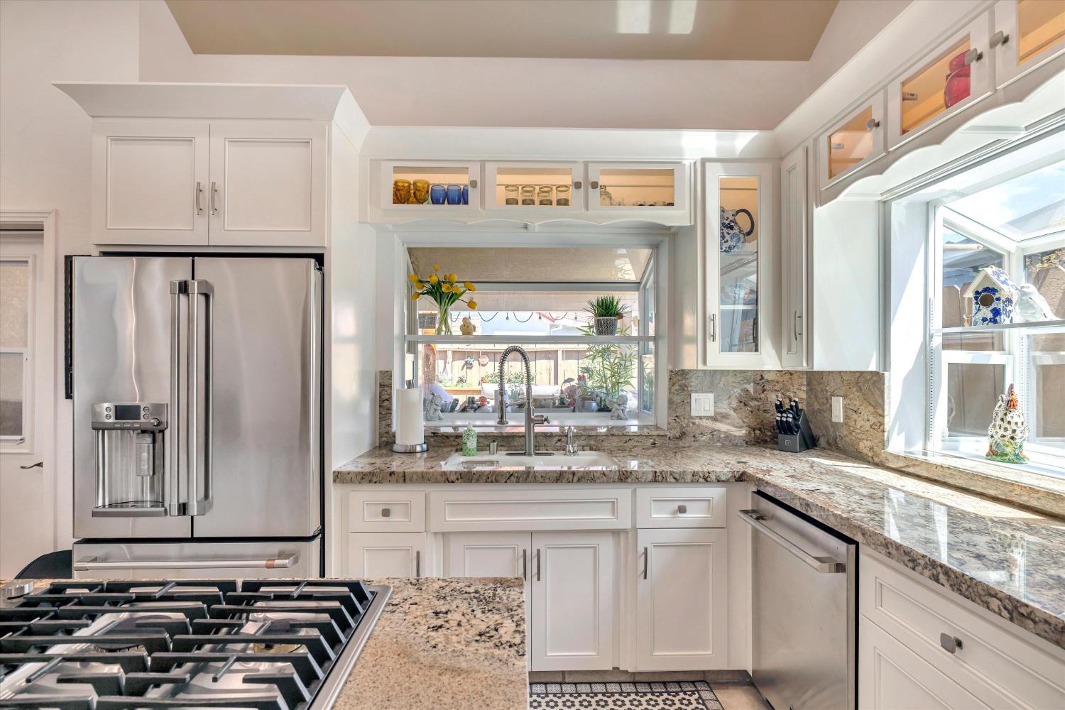 1412 Seneca Place Modesto, CA 95358 - Photo 19 of 62 a kitchen with stainless steel appliances granite countertop a sink stove and cabinets