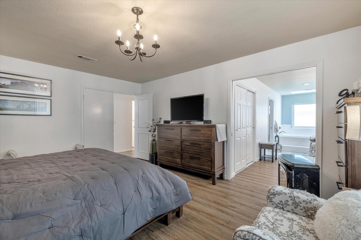 1412 Seneca Place Modesto, CA 95358 - Photo 25 of 62 a bedroom with a bed and a flat screen tv
