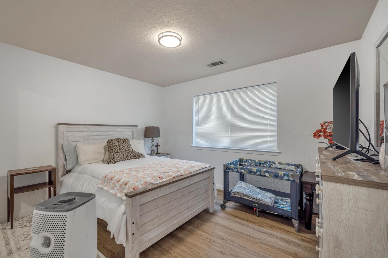1412 Seneca Place Modesto, CA 95358 - Photo 26 of 62 a bedroom with a bed and a flat screen tv