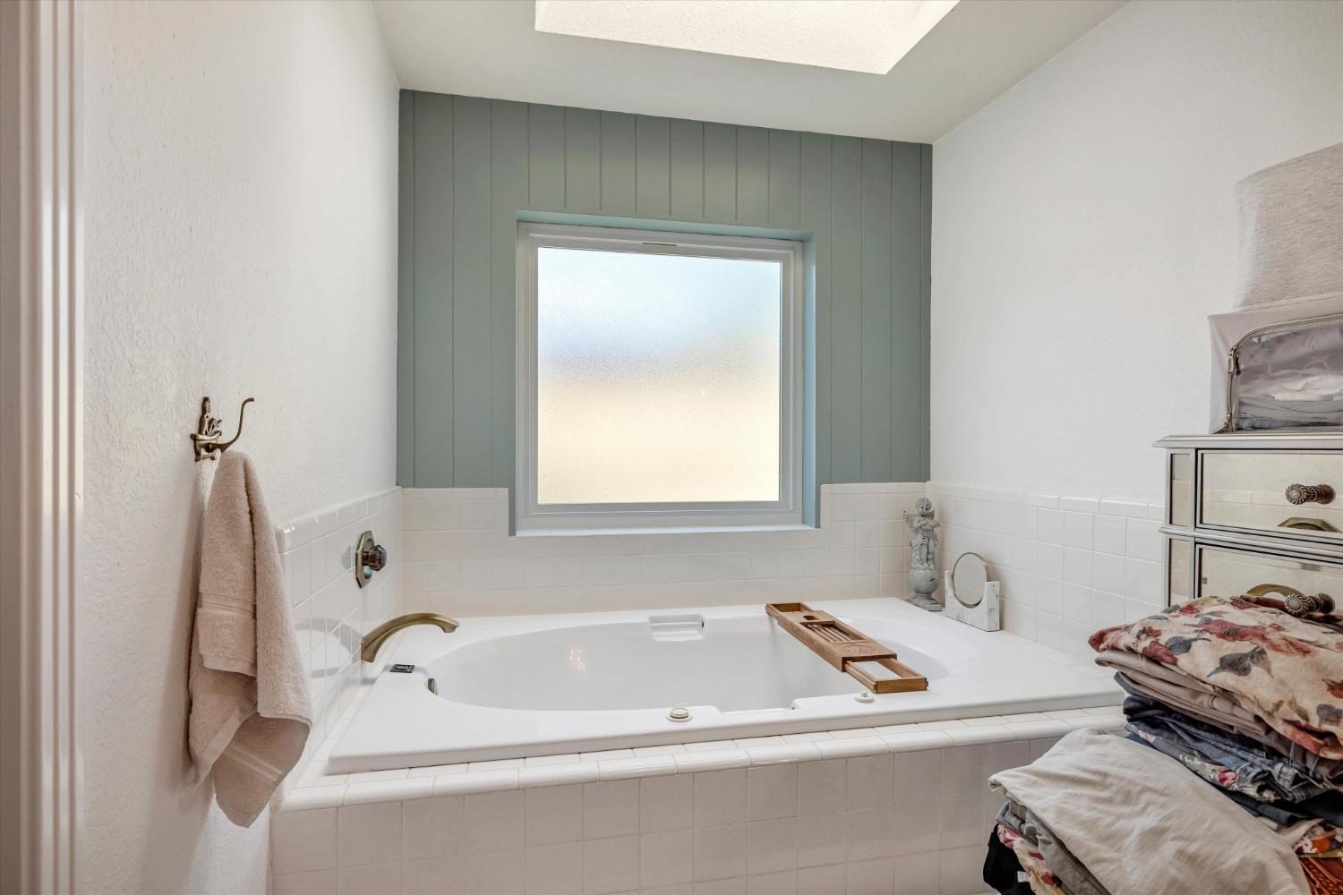 1412 Seneca Place Modesto, CA 95358 - Photo 31 of 62 a bathroom with a tub sink and a window