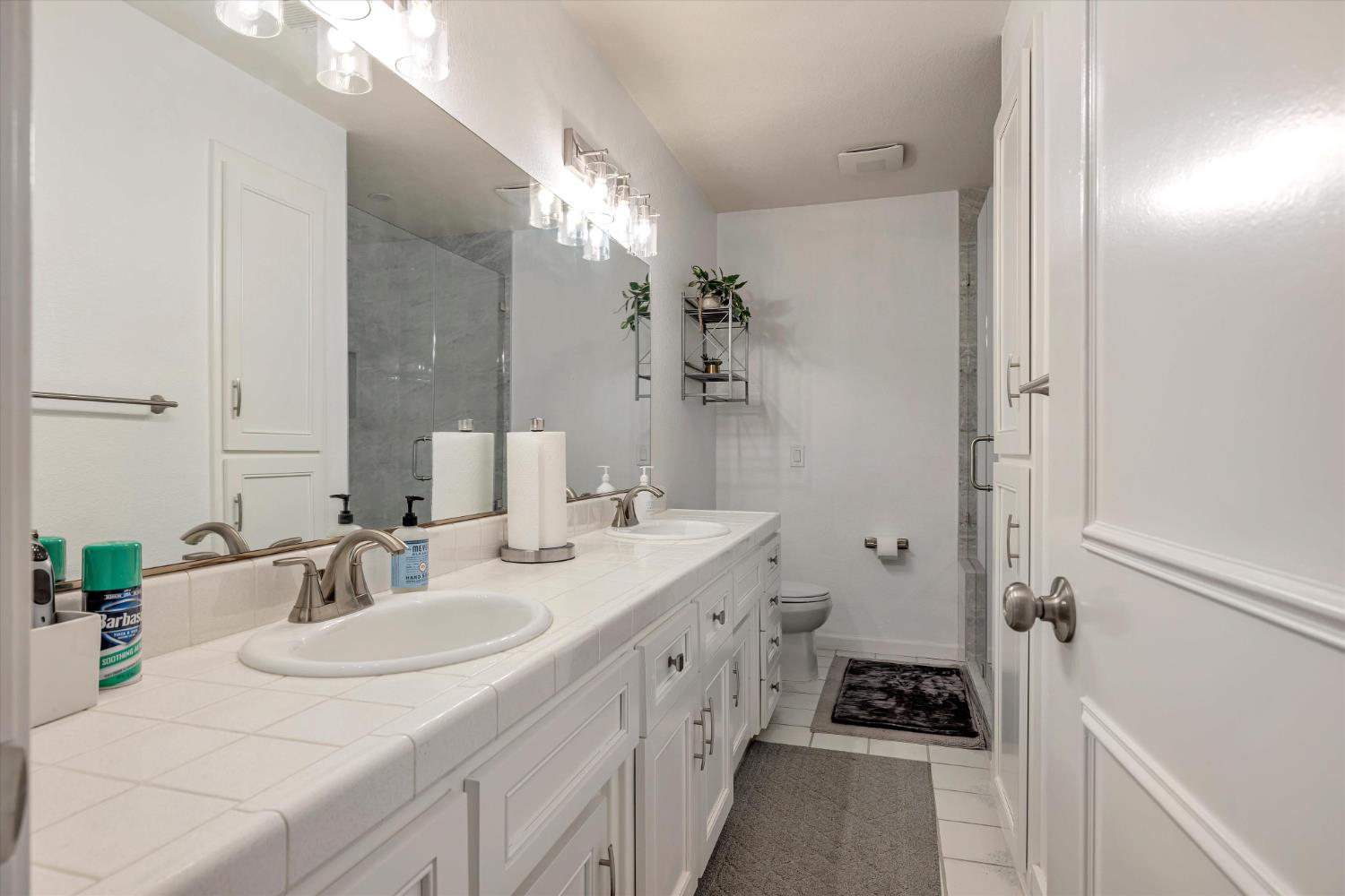 1412 Seneca Place Modesto, CA 95358 - Photo 34 of 62 a spacious bathroom with a double vanity sink a mirror a vanity and a shower