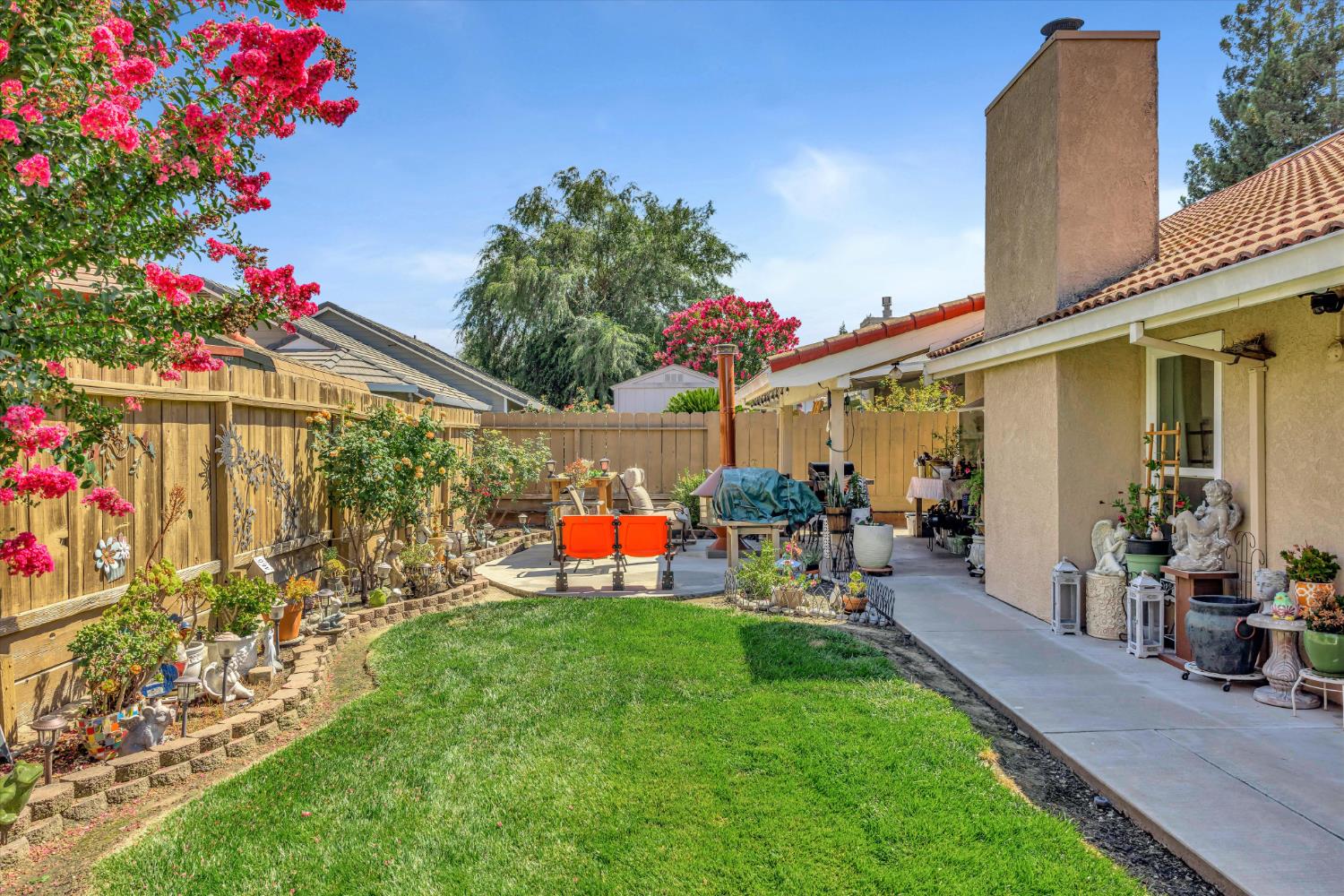 1412 Seneca Place Modesto, CA 95358 - Photo 40 of 62 a front view of a house with a big yard and potted plants