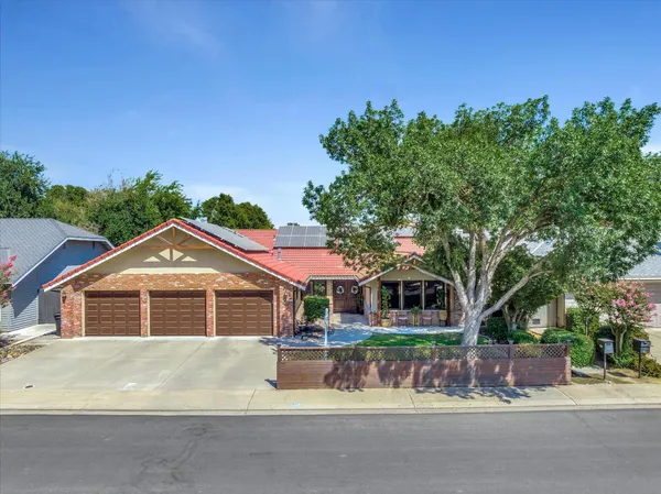 an aerial view of residential houses with outdoor space and street view