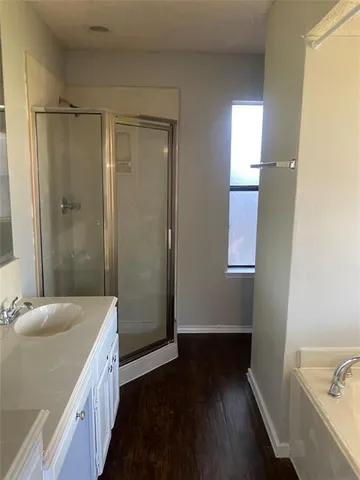 a bathroom with a sink a shower and a bathtub