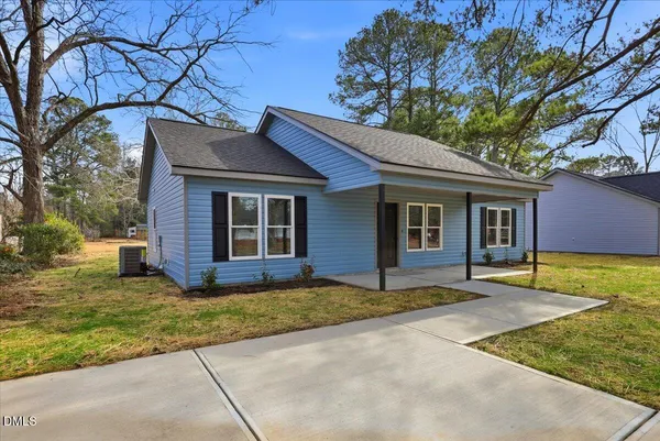 a house that has a tree in front of it