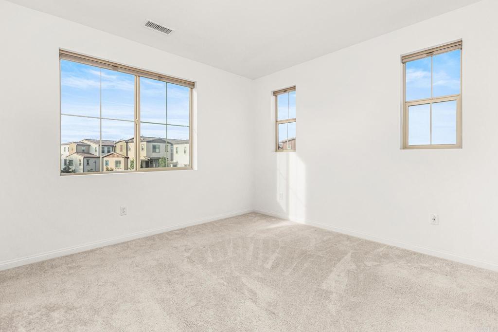 1609 Holly Leaf Way Oceanside, CA 92056 - Photo 12 of 26 an empty room with windows