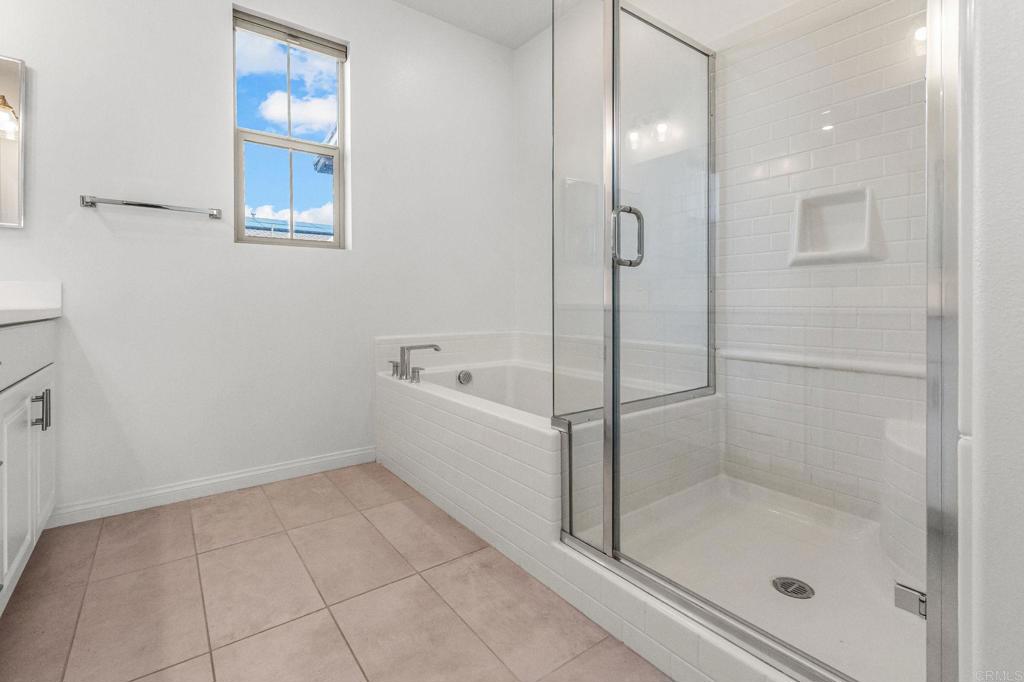 1609 Holly Leaf Way Oceanside, CA 92056 - Photo 15 of 26 a bathroom with a bathtub and a shower