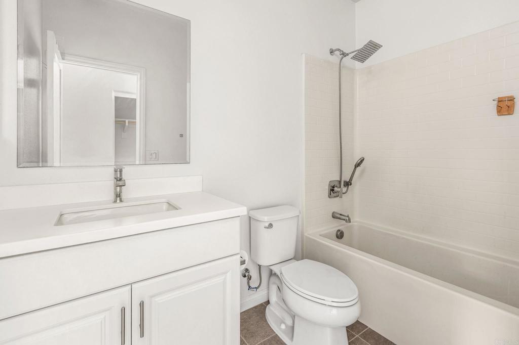 1609 Holly Leaf Way Oceanside, CA 92056 - Photo 20 of 26 a bathroom with a sink toilet vanity and tub