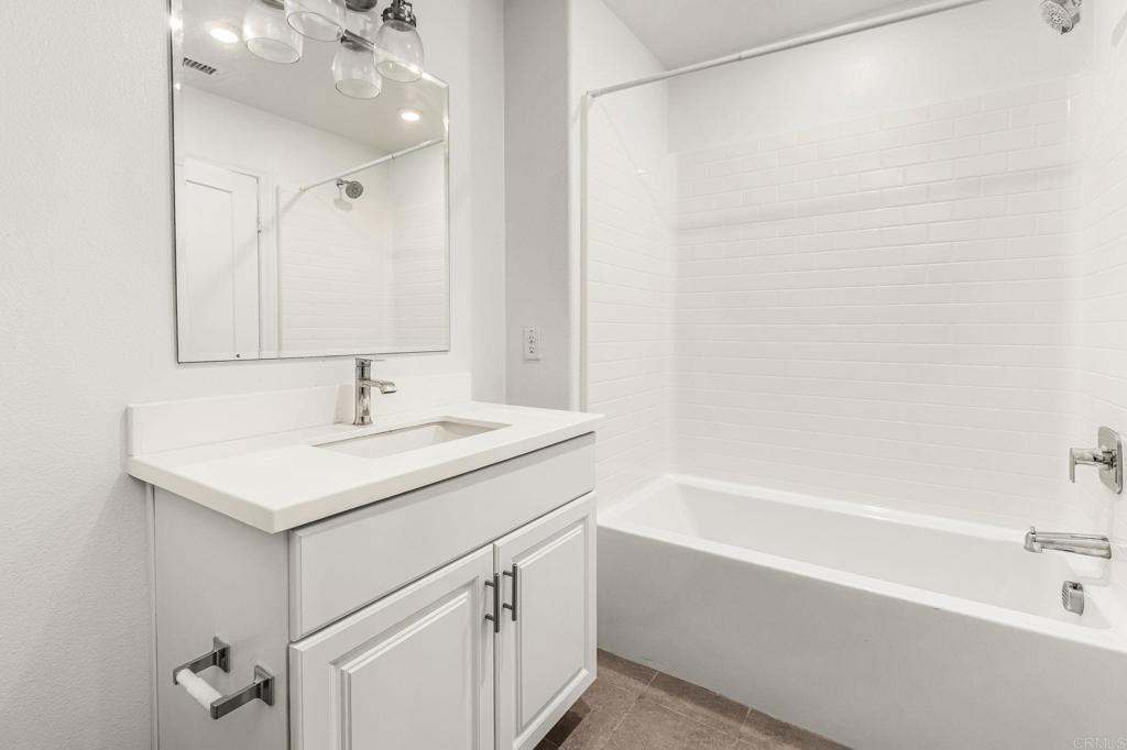 1609 Holly Leaf Way Oceanside, CA 92056 - Photo 22 of 26 a bathroom with a sink and a bathtub