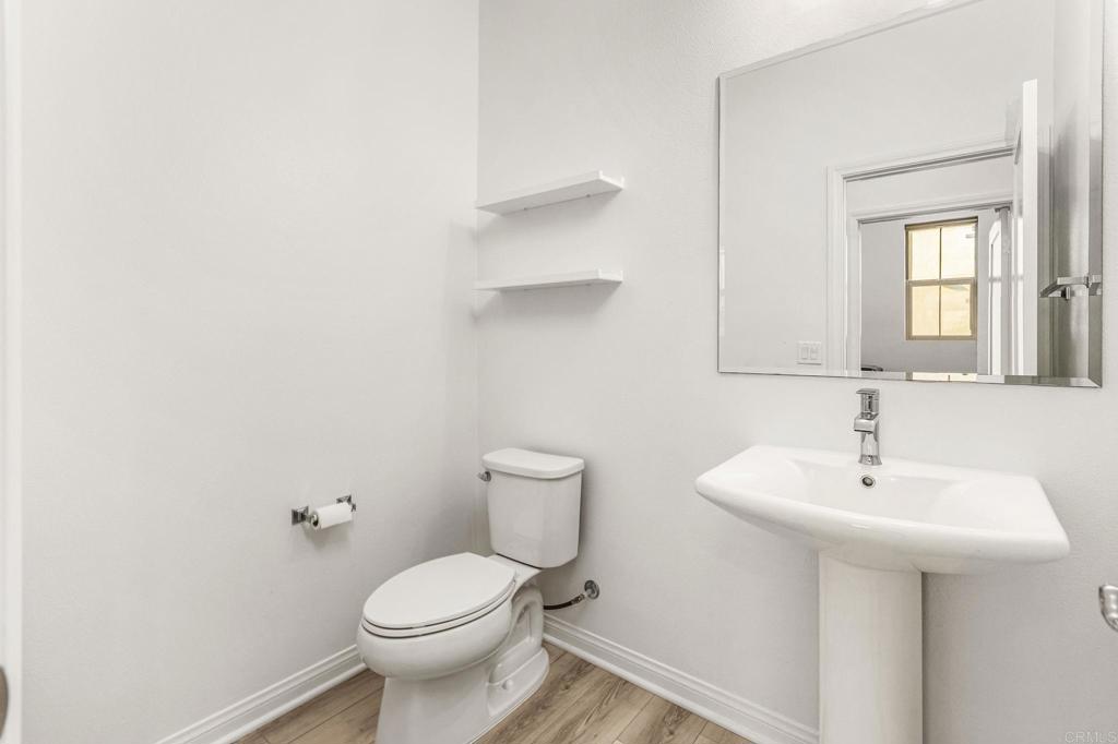 1609 Holly Leaf Way Oceanside, CA 92056 - Photo 23 of 26 a bathroom with a sink toilet and a mirror