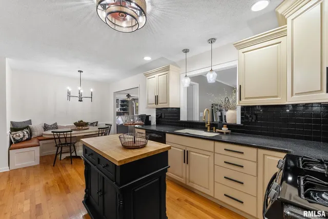 a kitchen with a sink stove and cabinets