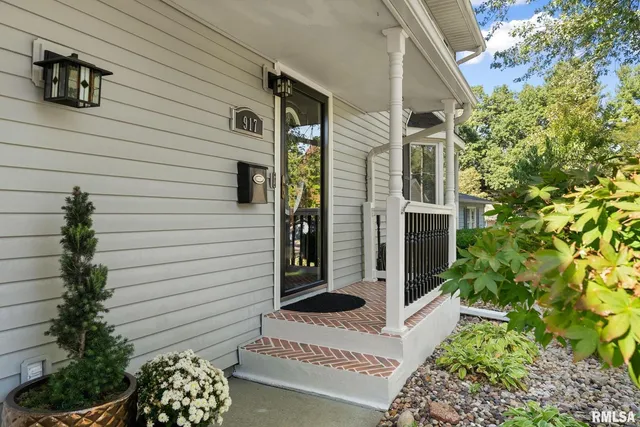 a front view of a house with plants