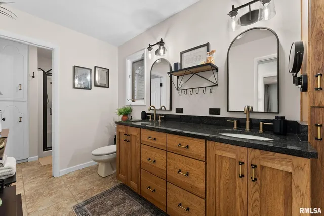 a bathroom with double sink and a mirror