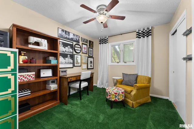 a living room with furniture and a book shelf