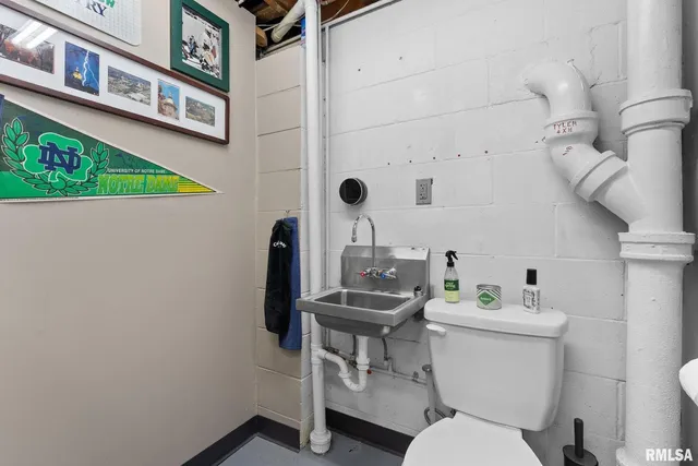 a bathroom with a toilet a sink and mirror