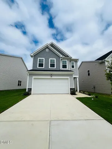 a house that has a big yard and large trees