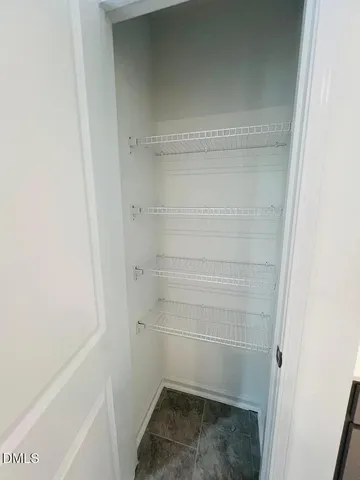 a spacious bathroom with a granite countertop sink mirror and cabinets