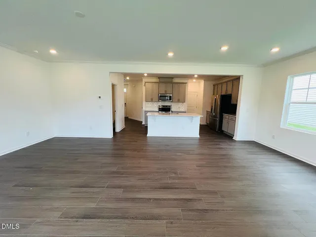 a view of kitchen and hall with wooden floor