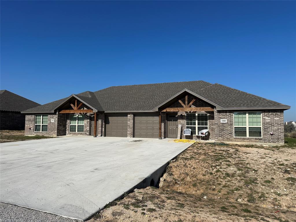 2211 Zion Hill Road, Unit 10011019 Weatherford, TX 76088 - Photo 2 of 5 a front view of a house with a yard