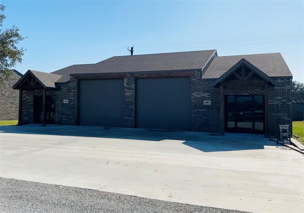 2211 Zion Hill Road, Unit 10011019 Weatherford, TX 76088 - Photo 3 of 5 a front view of a house with a yard and garage