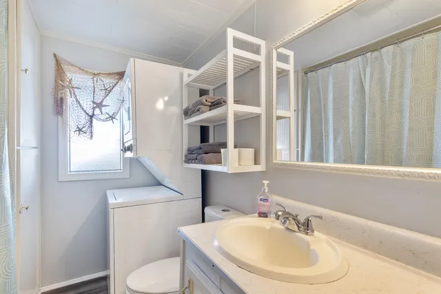 a bathroom with a sink toilet and shower