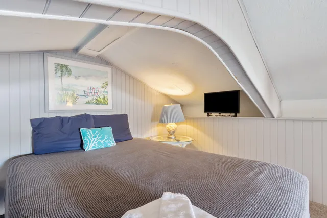 a bedroom with a bed and a television