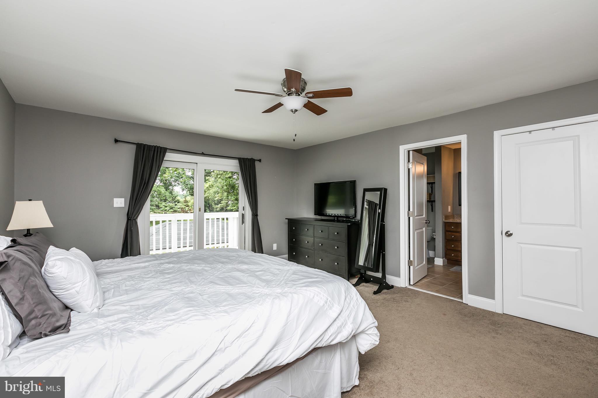 2905 Paper Mill Road Phoenix, MD 21131 - Photo 20 of 29 a bedroom with a bed and a chandelier