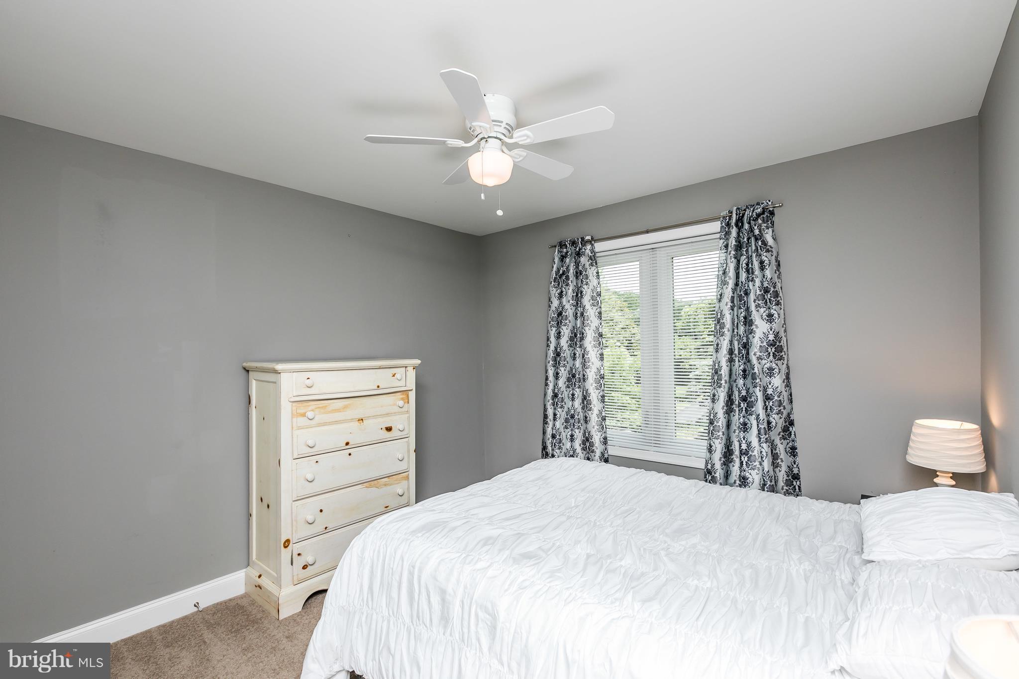 2905 Paper Mill Road Phoenix, MD 21131 - Photo 24 of 29 a bedroom with a bed and a chandelier