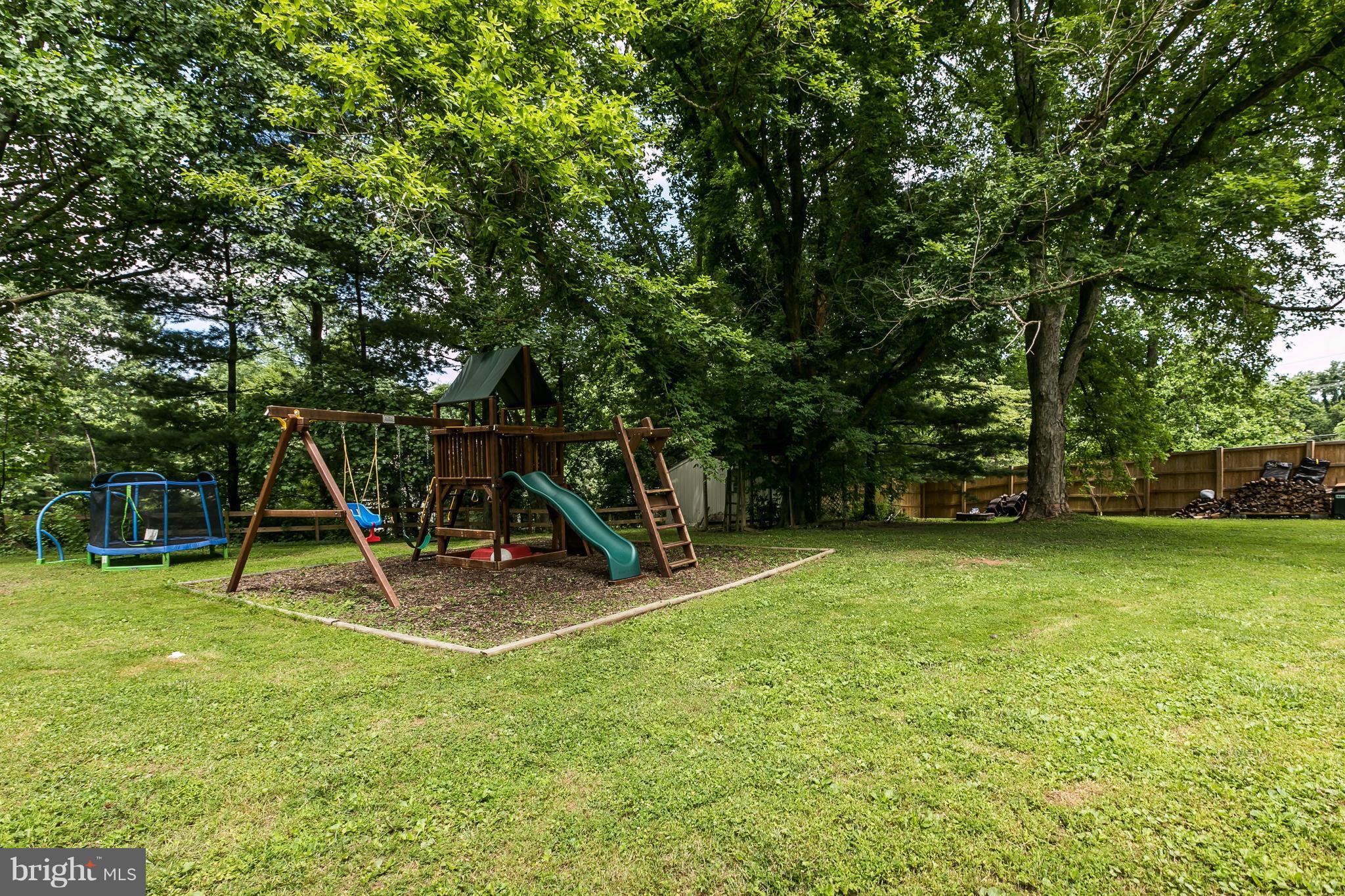 2905 Paper Mill Road Phoenix, MD 21131 - Photo 28 of 29 a view of a backyard with a slide trees and wooden fence
