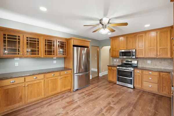 a kitchen with wooden cabinets and stainless steel appliances