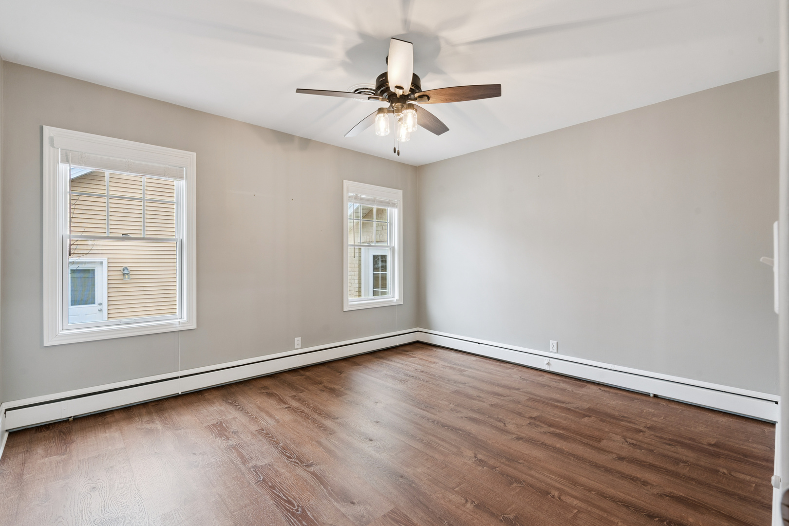 1416 6th Street Orion, IL 61273 - Photo 20 of 48 an empty room with wooden floor chandelier and windows