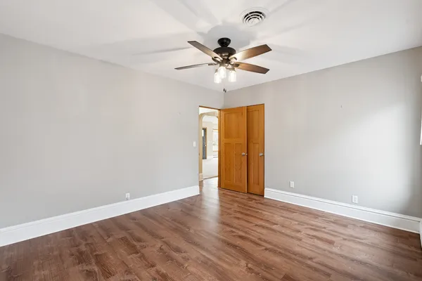 a view of an empty room with wooden floor
