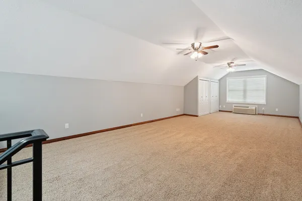 a view of empty room with ceiling fan